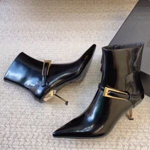 Sleek Black Heeled Boots with Gold Buckle